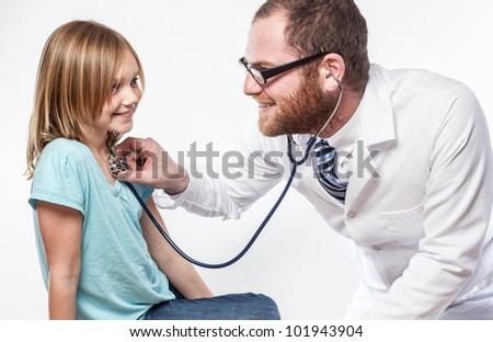 stock-photo-girl-in-blue-shirt-getting-check-up-at-pediatric-clinic-with-friendly-bearded-young-doctor-white-101943904.jpg