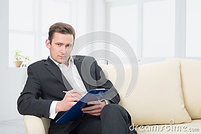 male-psychologist-being-ready-to-take-notes-sitting-couch-31680668.jpg