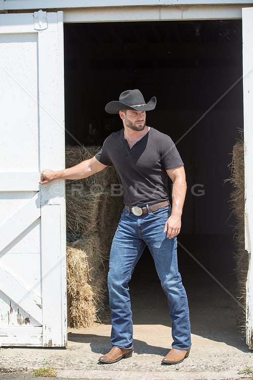 muscular-cowboy-opening-a-barn-door.jpg